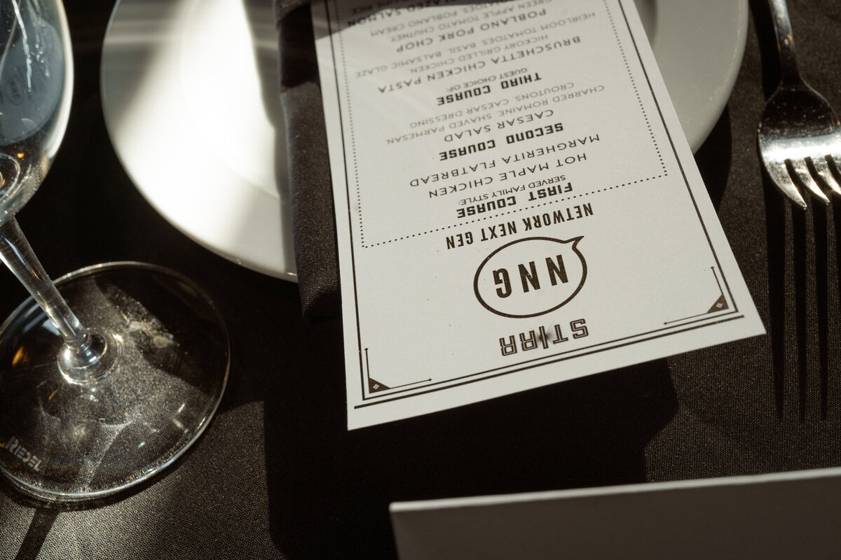 A sophisticated table setting featuring a branded NNG place card at the private networking dinner. The details reflect the thoughtful planning behind the evening, designed for interior design professionals to connect in style.