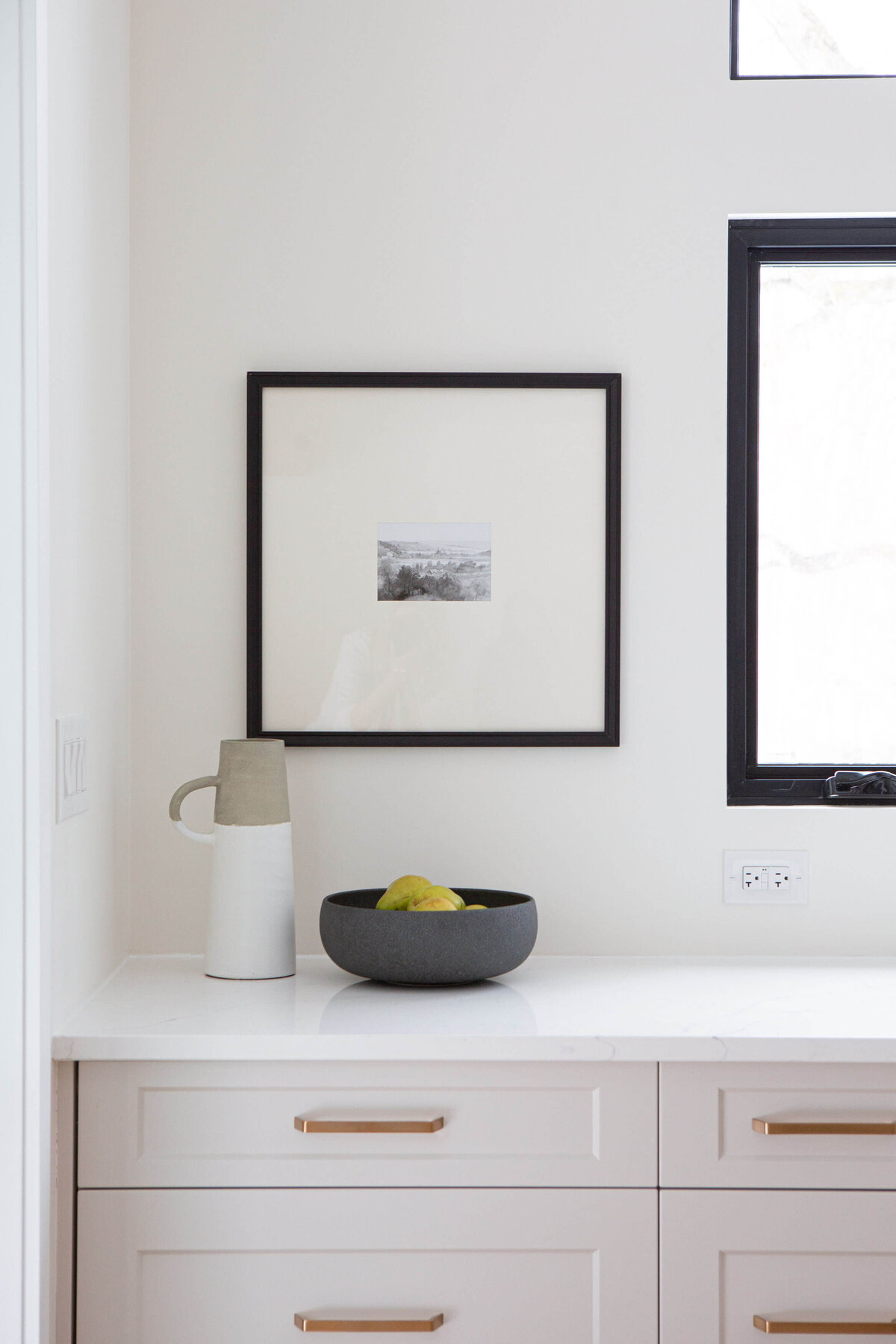 winnipeg luxury show home kitchen with hand made ceramic pitcher and bowl on white countertop