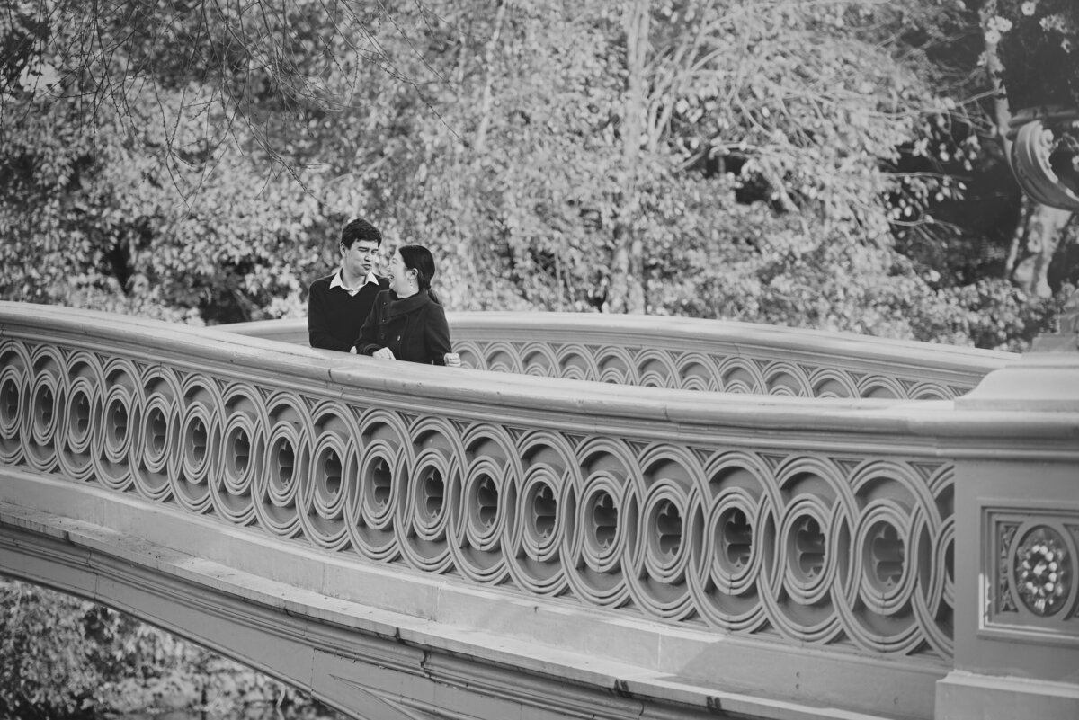 A couple about to kiss while they are on a bridge