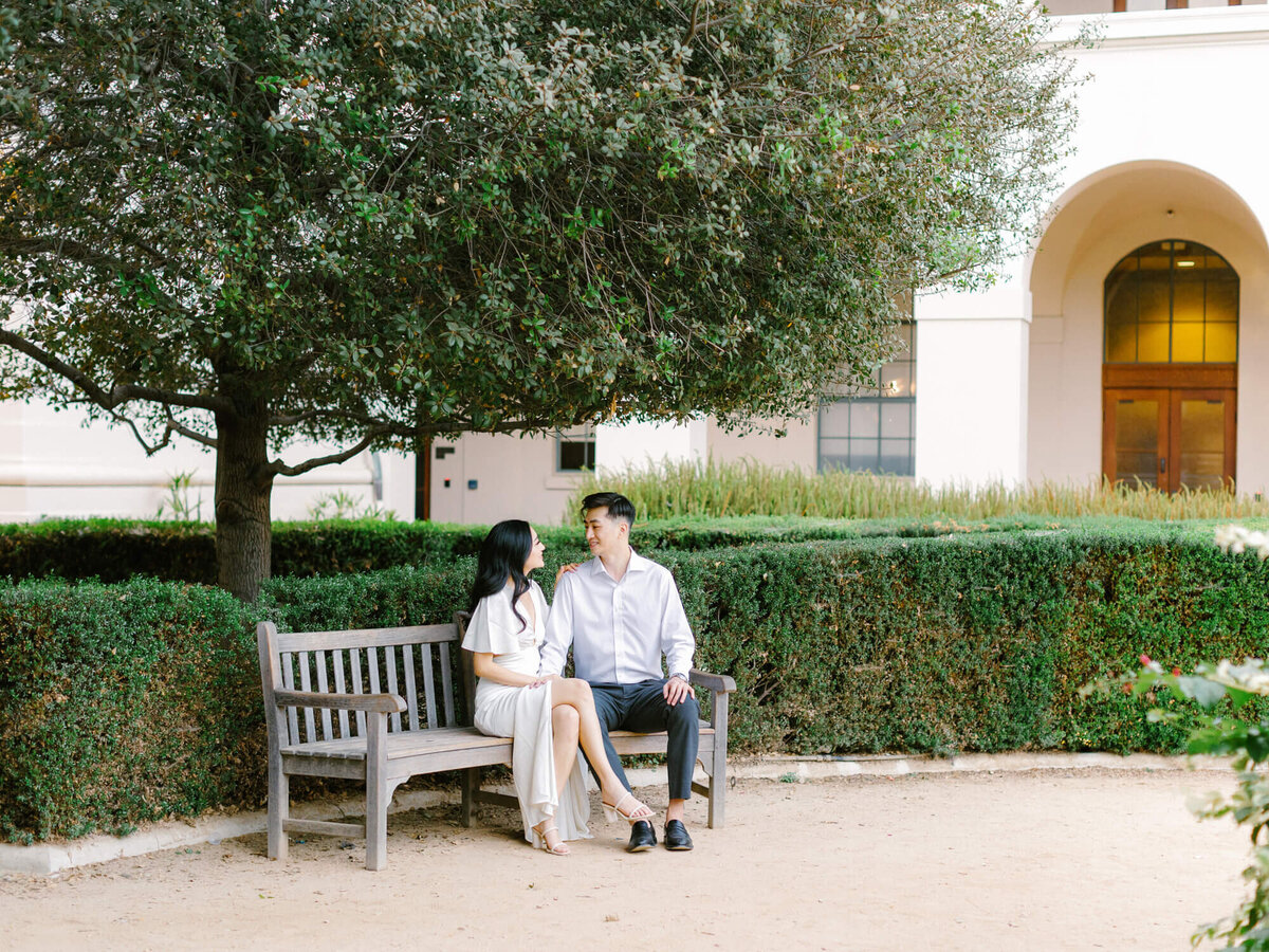 couple sitting on a bench at courtyard