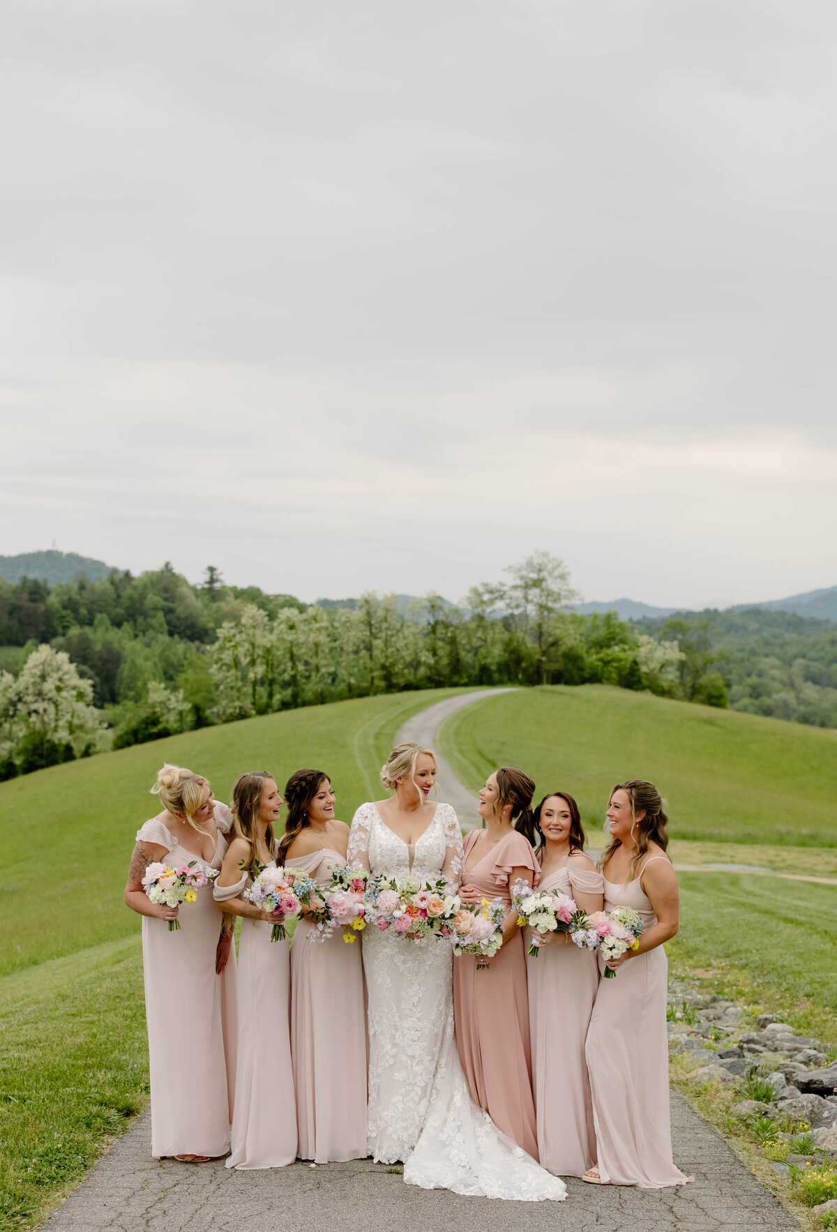 Bride and bridesmaids with colorful bouquets designed by Abby Grace Florals at NC wedding