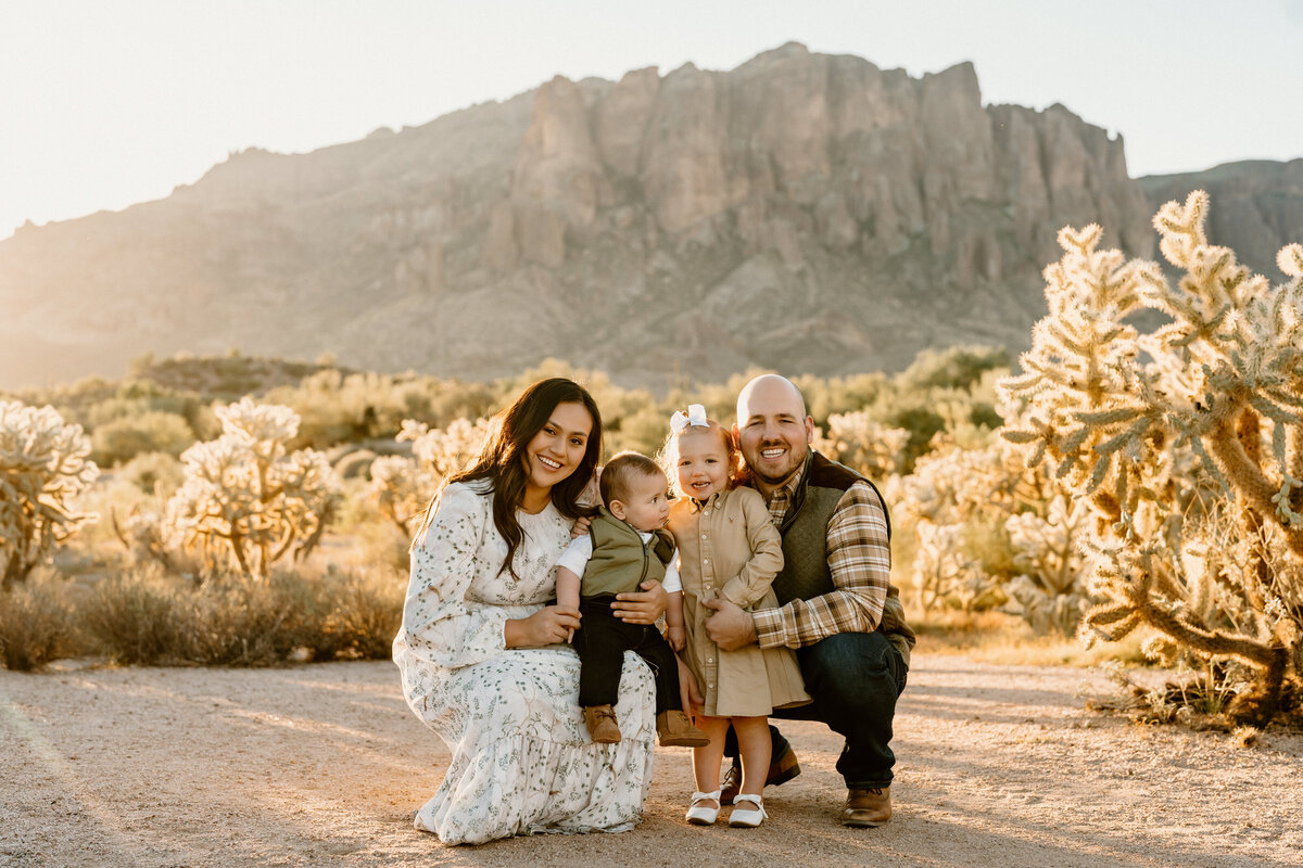 parents kneel with two kids in arizona landscape