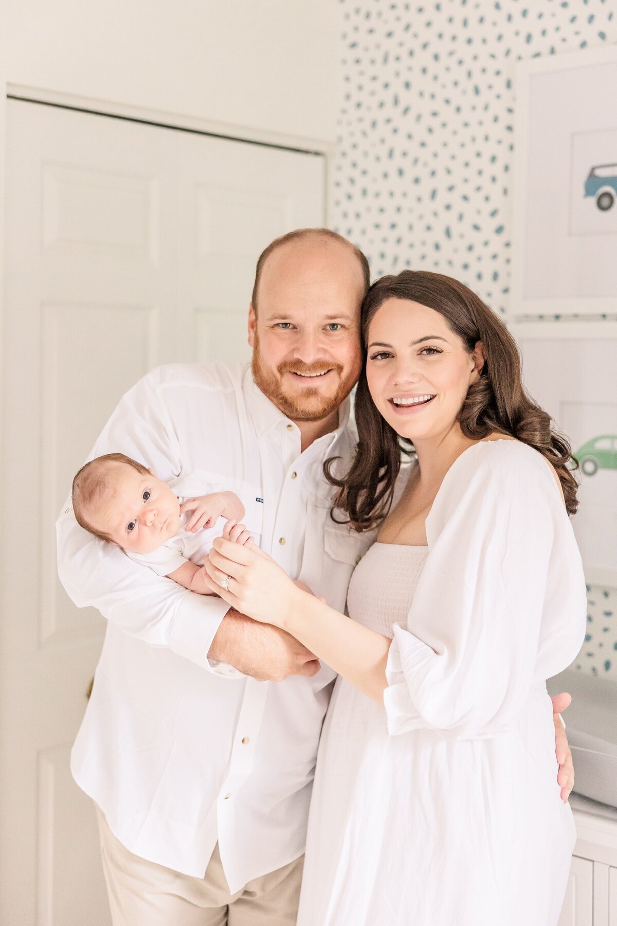 Parents smiling with their newborn for an Ohio family photographer