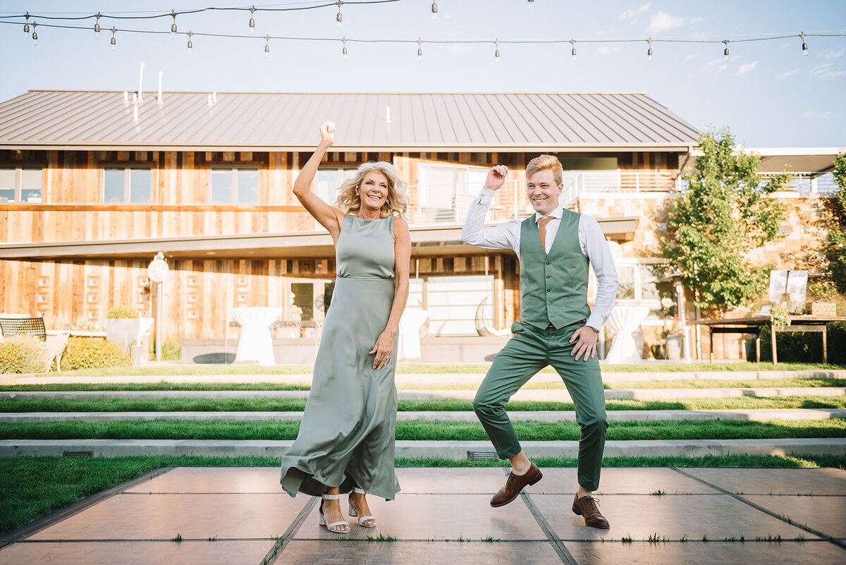 Groom and his mother dance together on his wedding day both in green in Colorado.