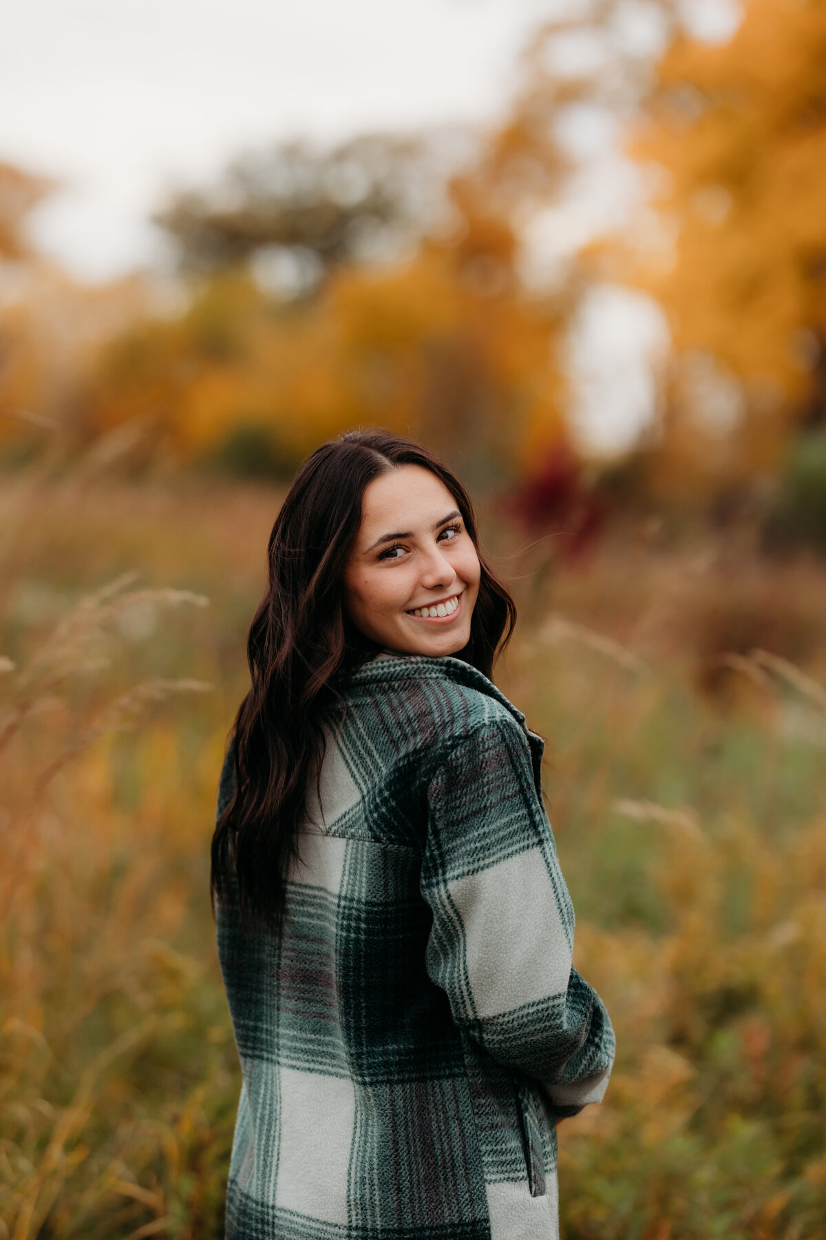 A high school senior during fall in a field  at Hadley Valley in Joliet.
