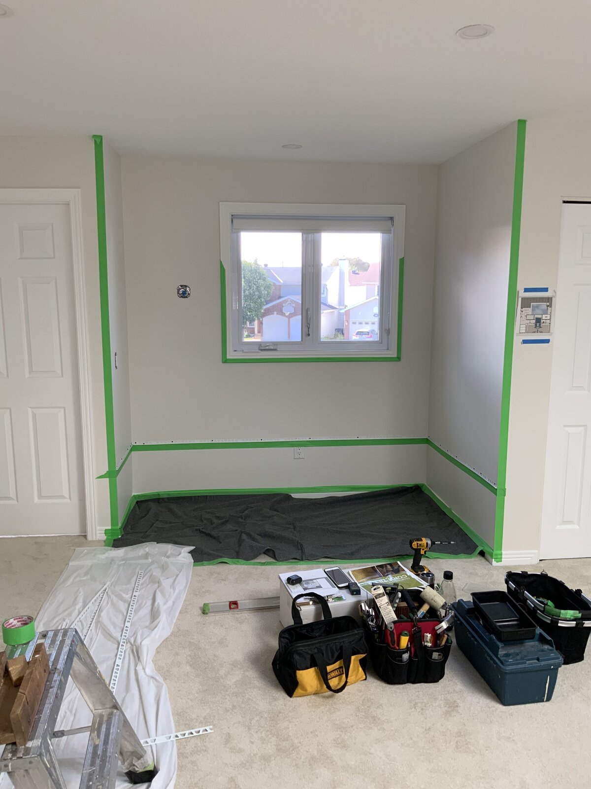 Here the cork wall tile layout is taped off prior to installation, in this hallway nook being turned into a compact home office space. 