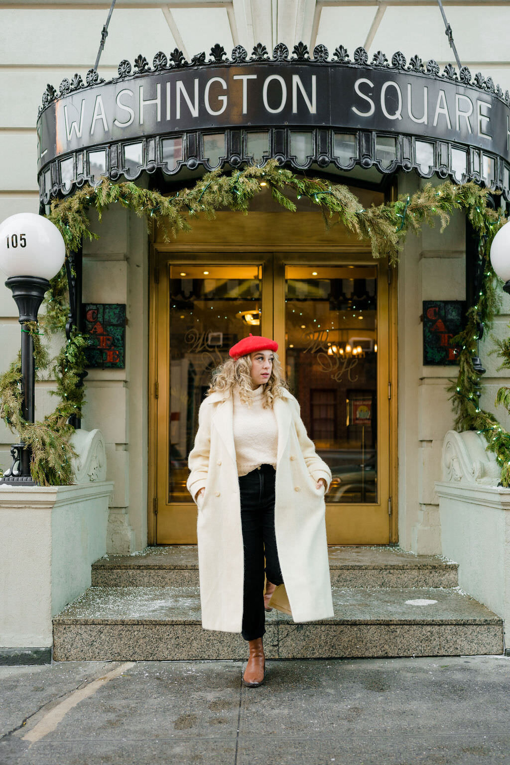 woman walking out of a storefront with her hands in her coat pocket