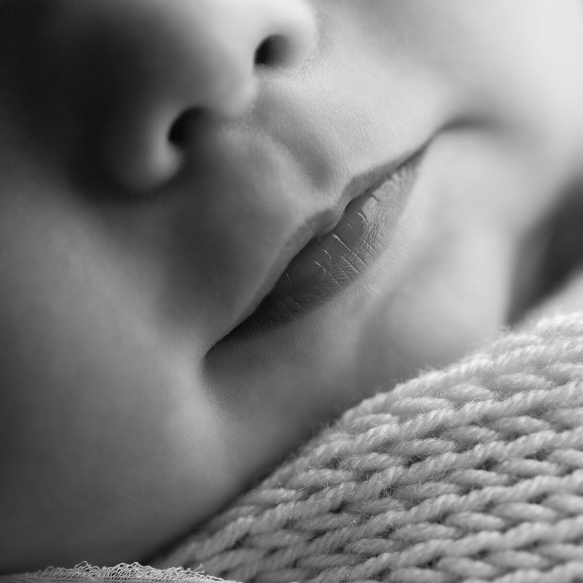 A tender macro of newborn lips at rest—pure, peaceful, and forever timeless.