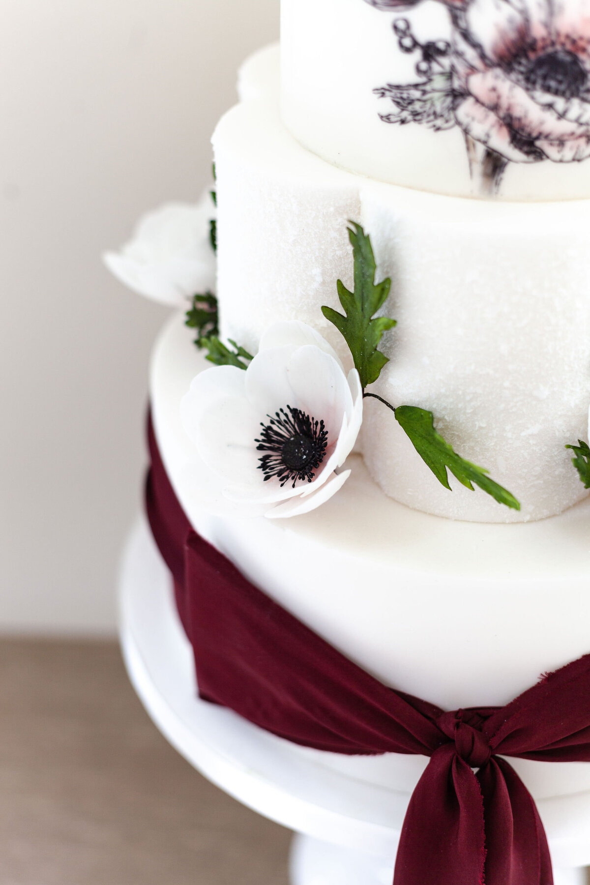 Luxury nature inspired wedding cake designer vanilla Spice Cake Studio Northamptonshire sugarcraft anemone flower 3 tiered cake silk ribbon