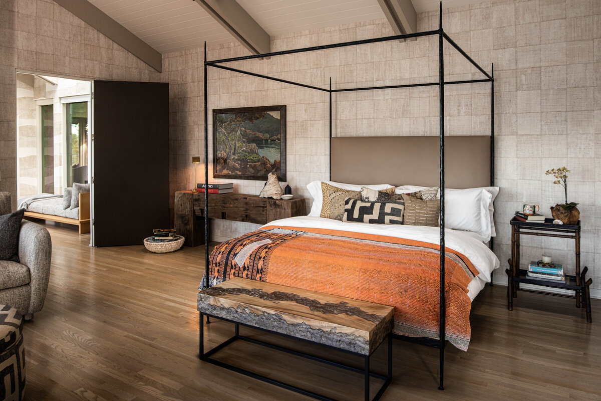 Spacious bedroom with canopy bed and rustic decor, highlighted in interior photography