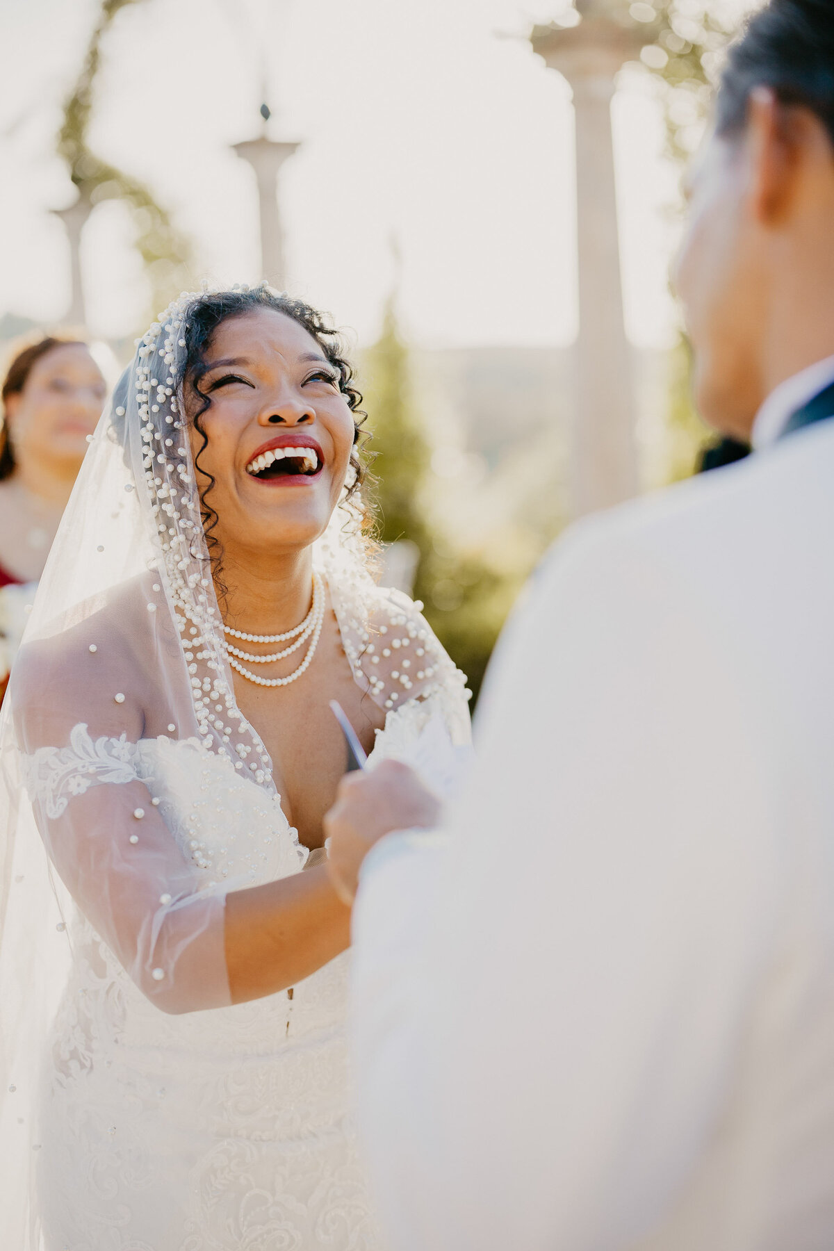 Smiling bride during the ceremony at Tenuta Corbinaia, elegant wedding in Tuscany.