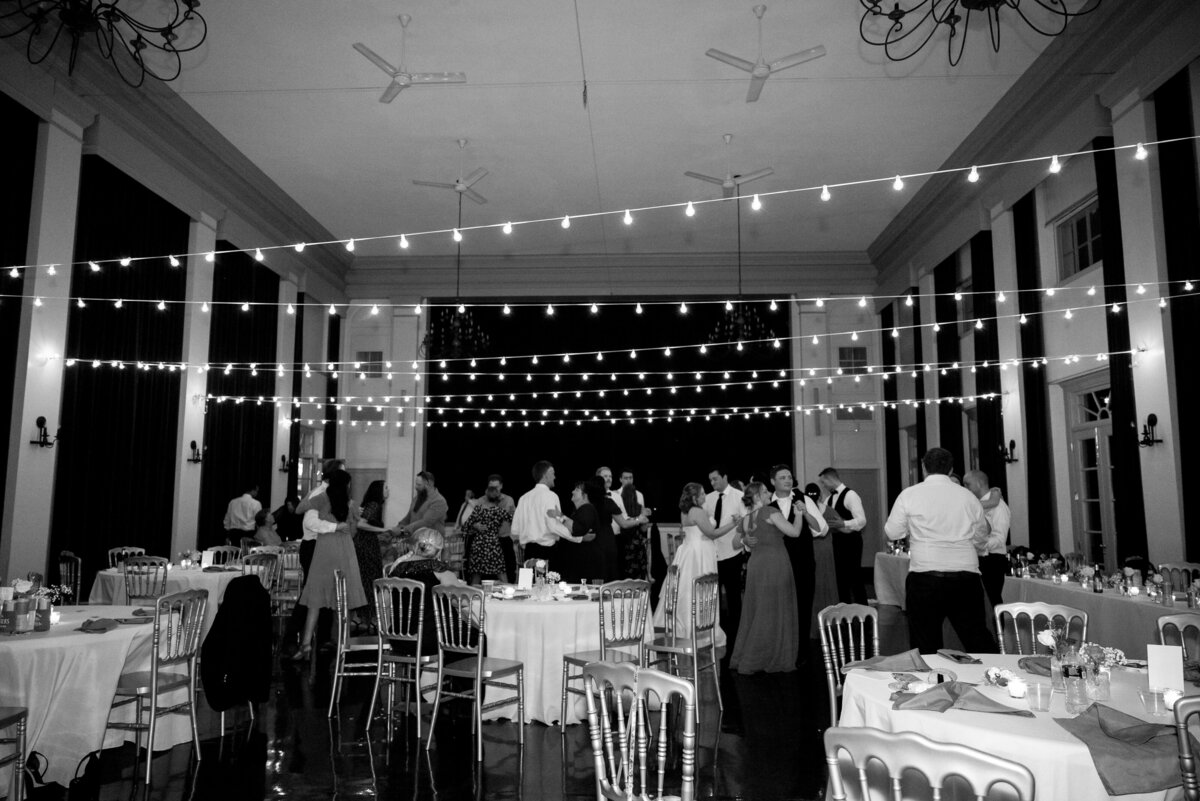 black and white wedding reception picture at middleburg community center with wedding guests mingling
