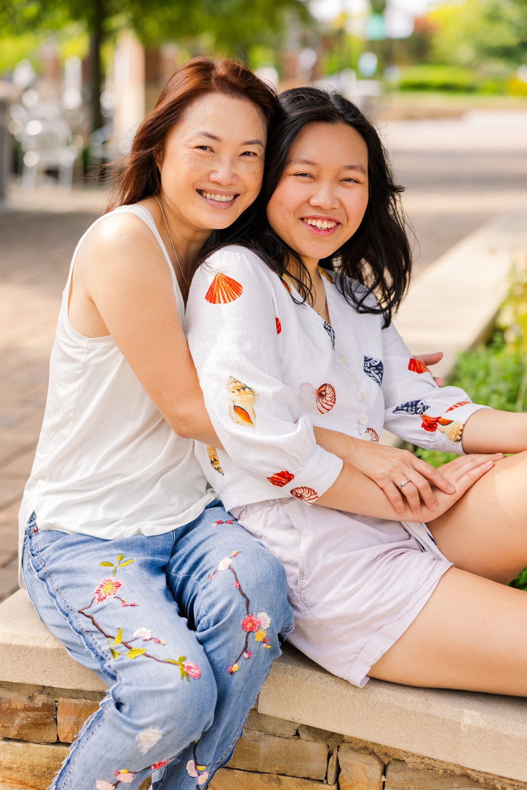 mummy and daughter photo sitting during senior portraits mum hugging her daughter