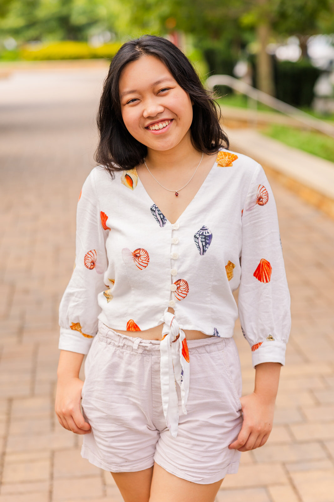 senior girl standing on the middle of a urban path during portraits photoshoot