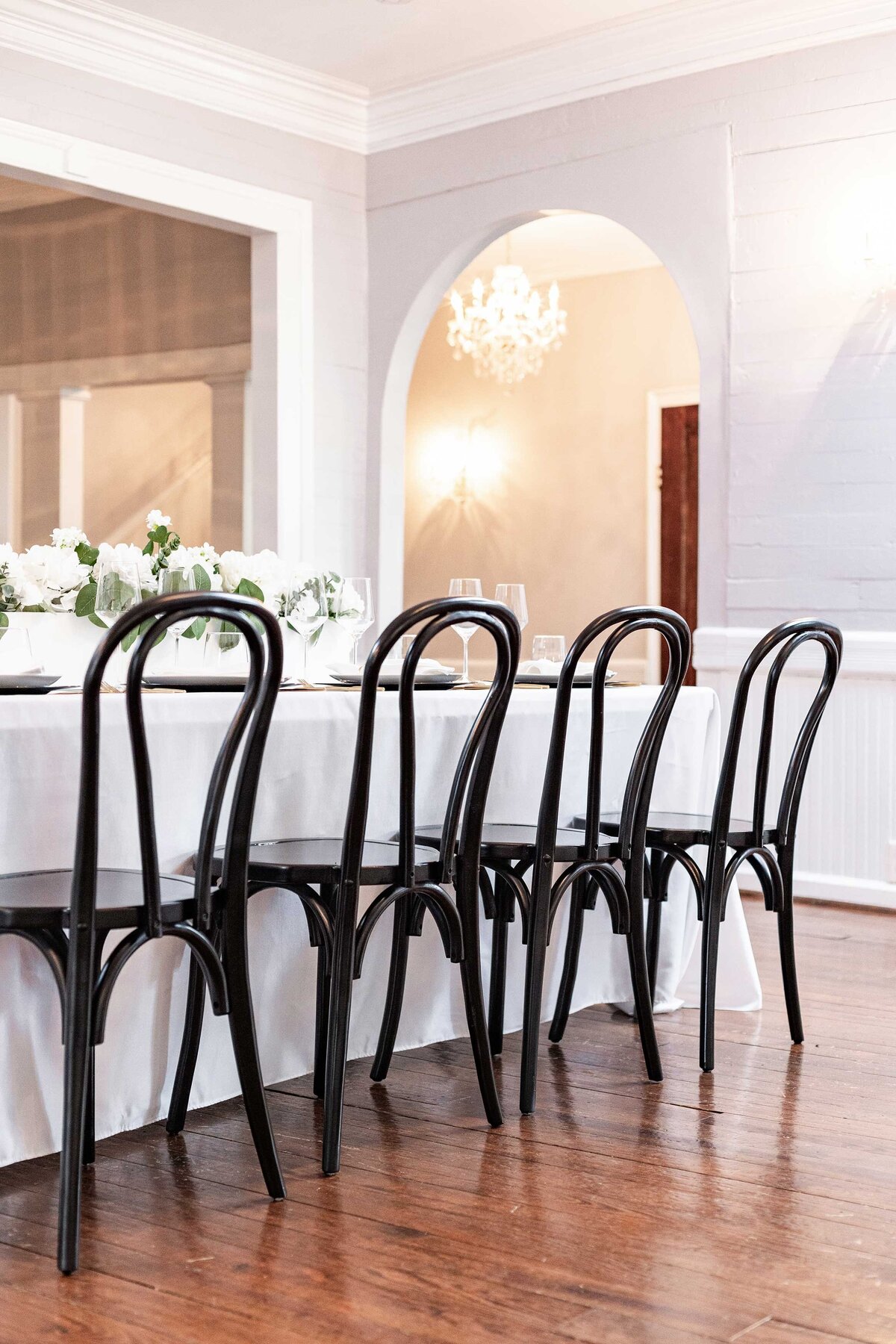 Discover elegant event rentals for weddings featuring sophisticated white and black tables and chairs, perfect for a stylish and refined celebration.