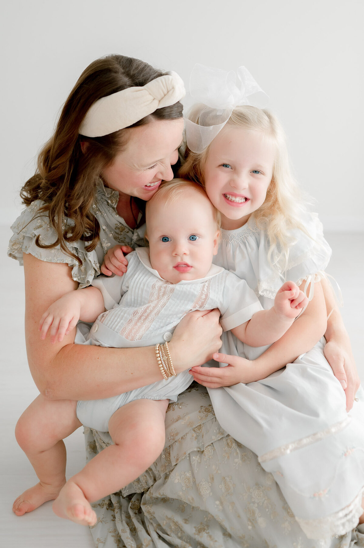 Mother hugs her two children