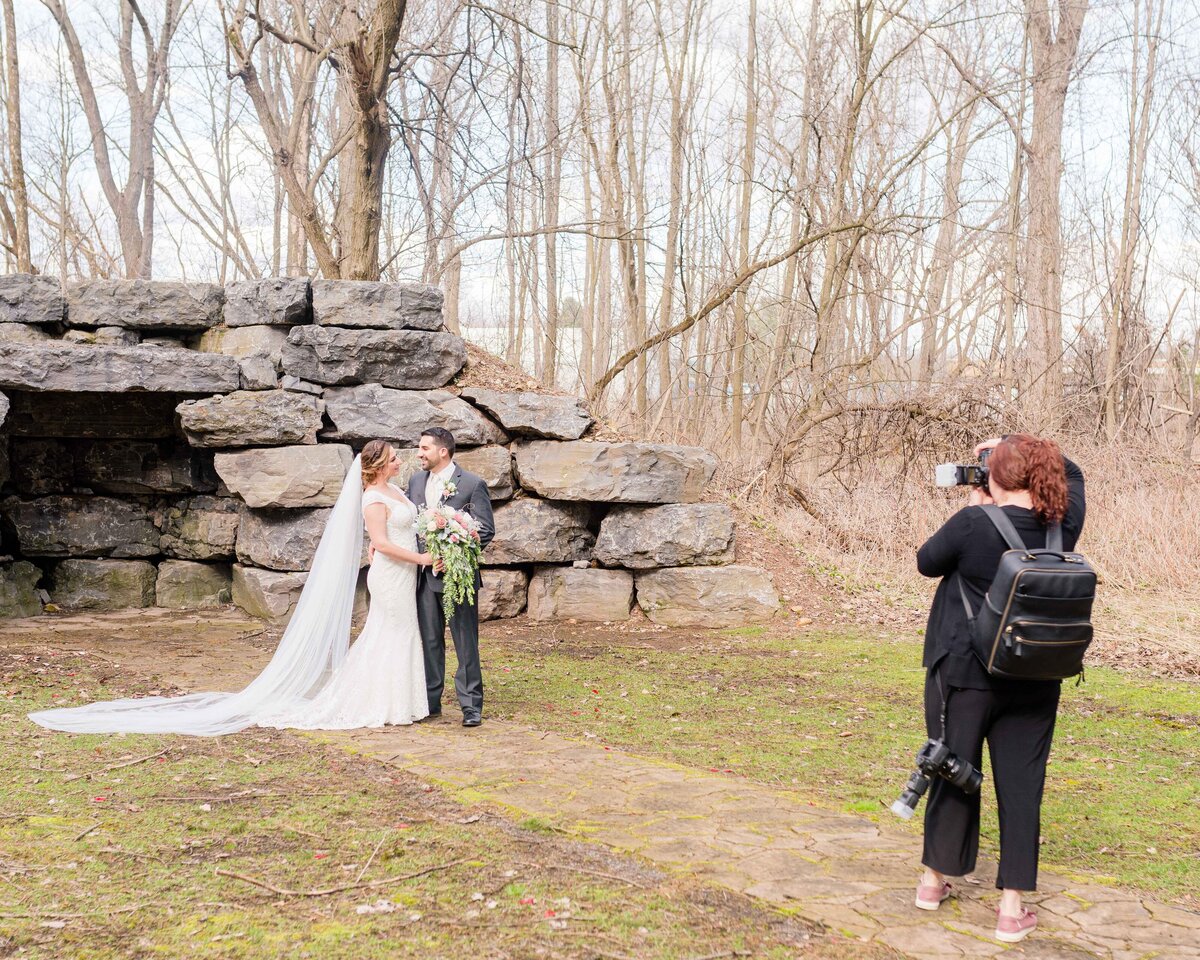 Photographer taking photo of bring and groom