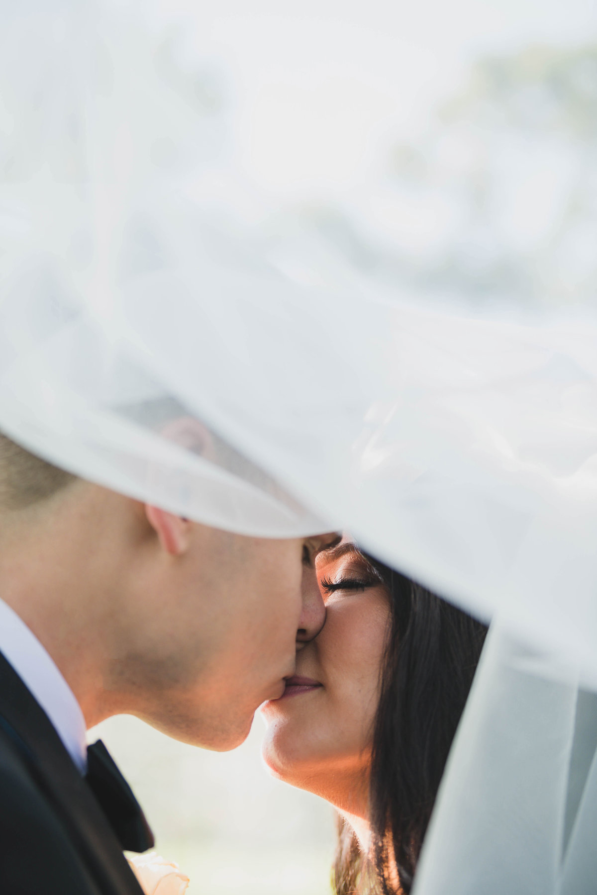 bride and groom kissing photo from wedding at The Muttontown Club
