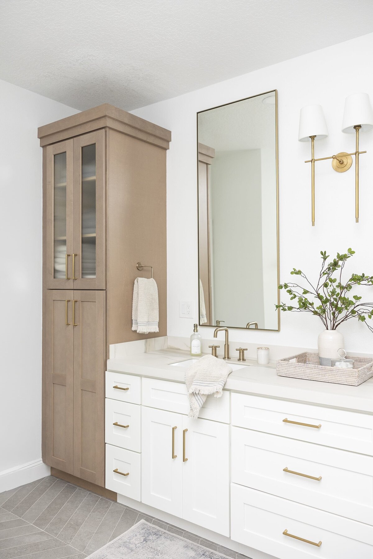 dewine design orlando interior designer contemporary coastal primary bathroom neutral tone with wooden cabinets and gold hardware
