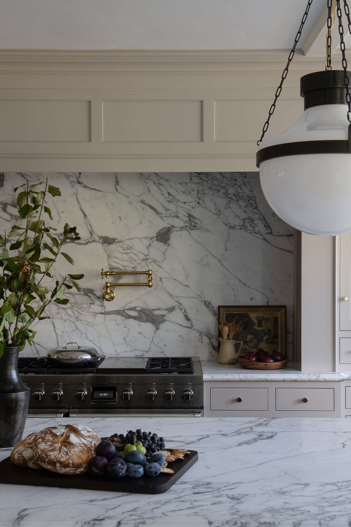 english-tudor-kitchen-marble-backsplash-and-brass-potfiller.