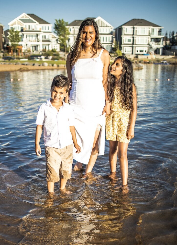 Mother with her son and daughter standing in a lake