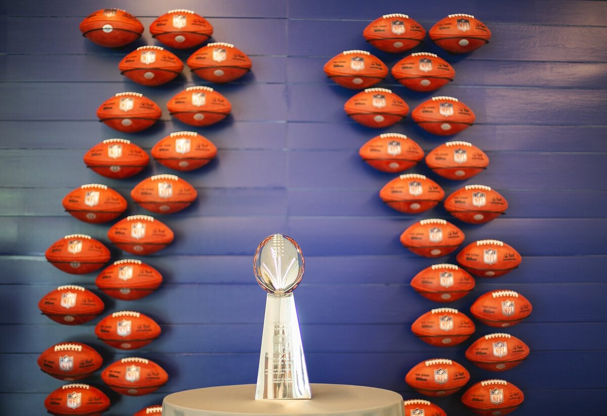A-vince-lombardi-trophy-stands-on-display-at-an-nfl-themed-event-in-indianapolis-surrounded-by-autographed-footballs-at-colts-complex