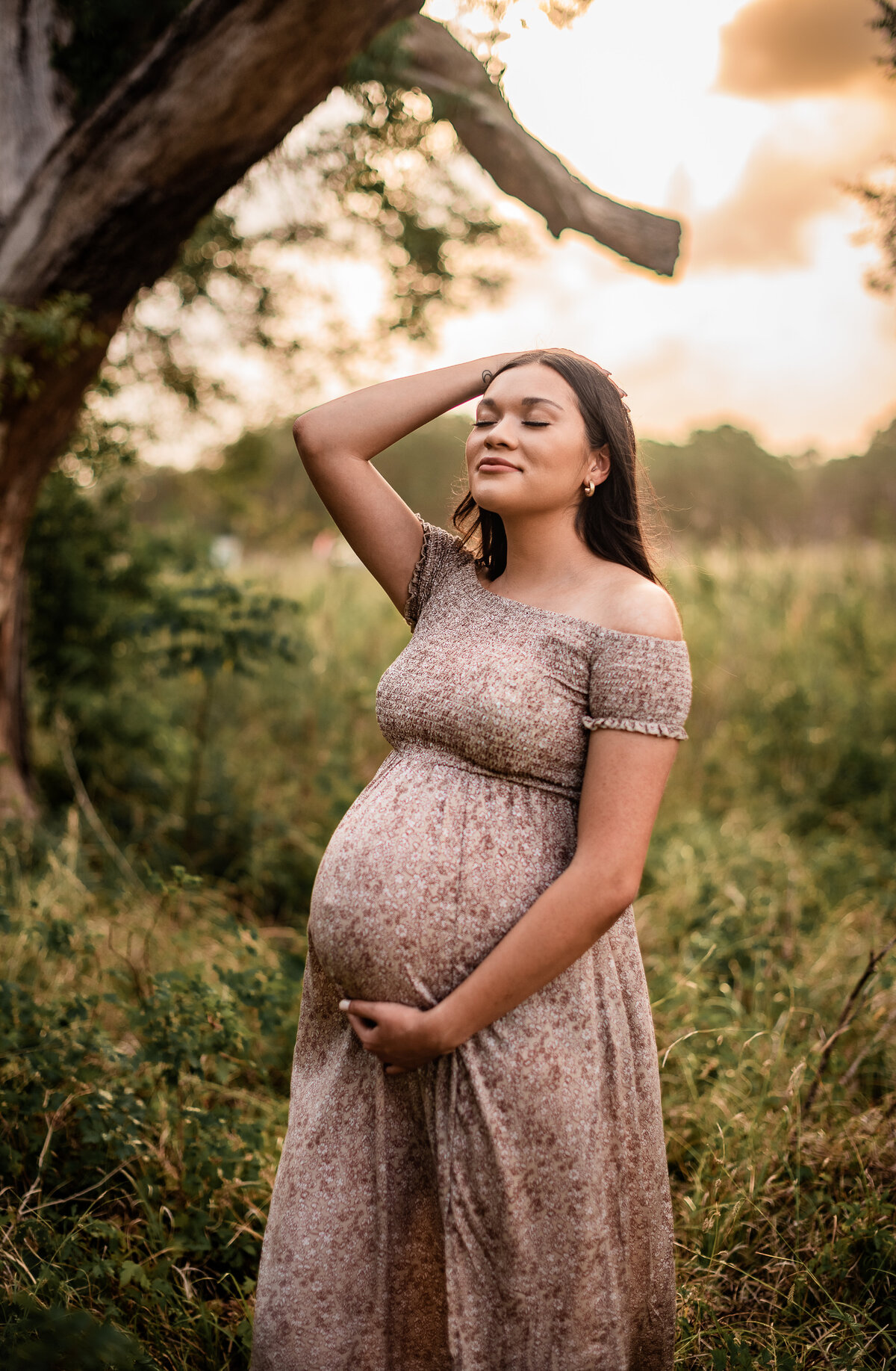 A mother to be leans her head back and basks in the glow of pregnancy at Brazos Bend State Park.