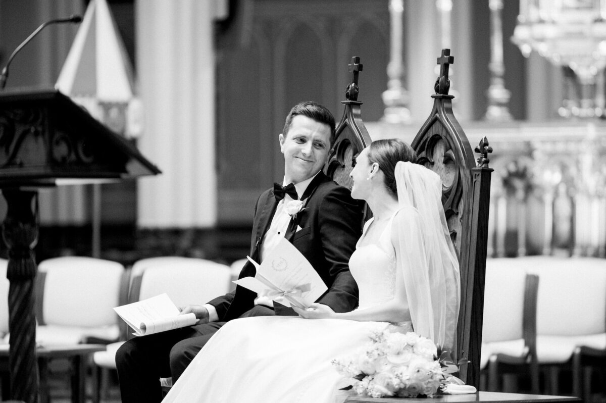 bride and groom looking at each other lovingly during a Catholic wedding Mass