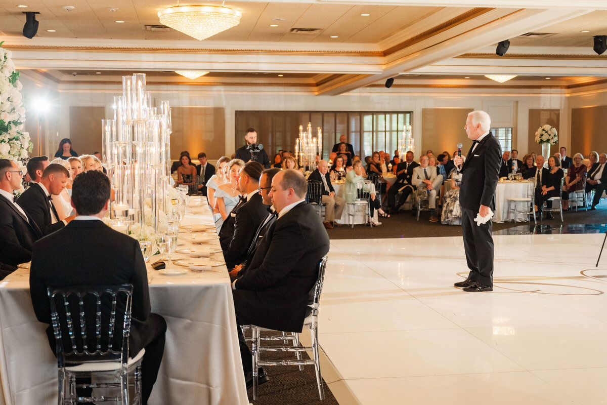 dad standing in the middle of the dance floor giving a wedding speech during his daughters The Grand Resort wedding