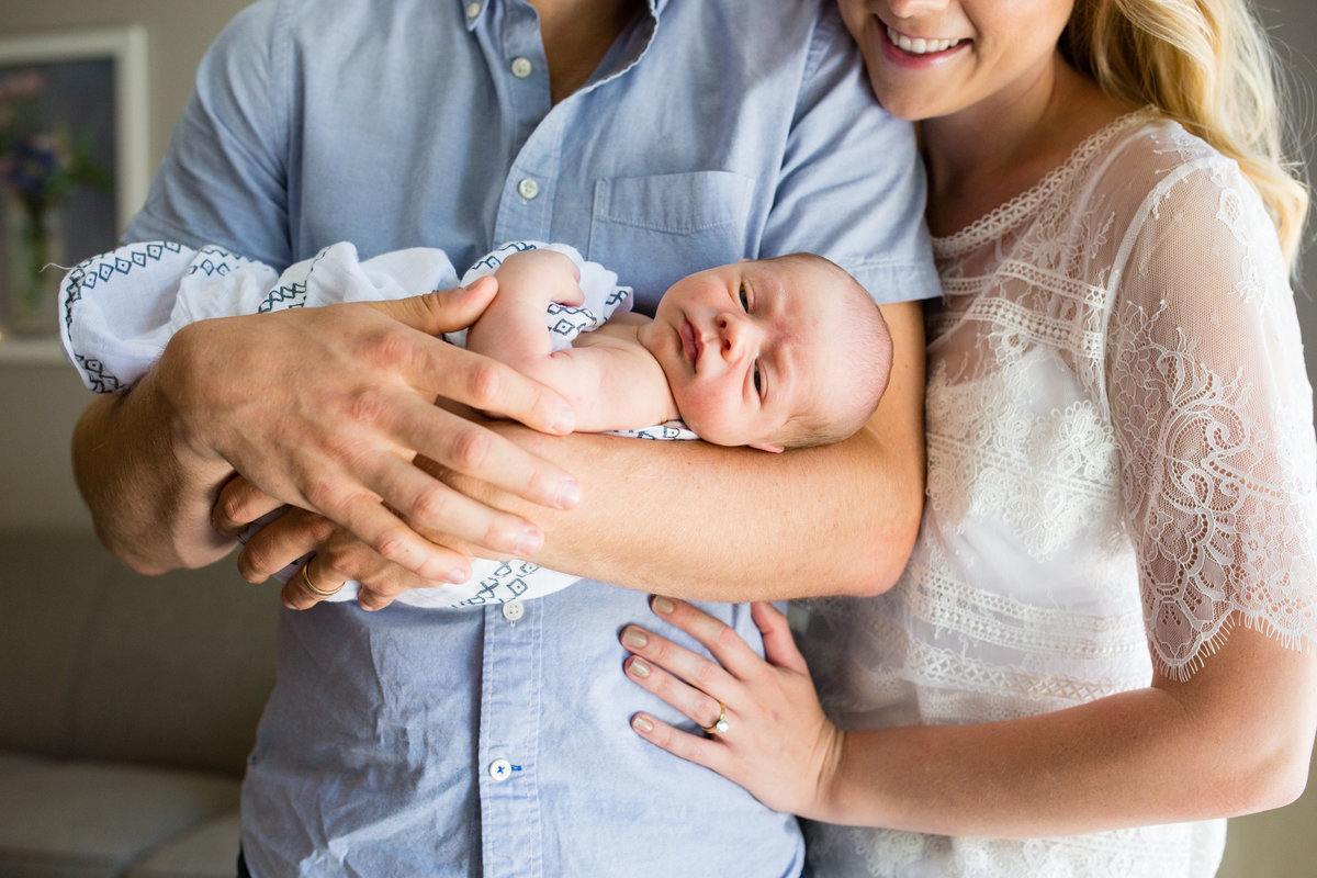 Parents holding new baby  - Jen Madigan - Plainfield Newborn Photographer