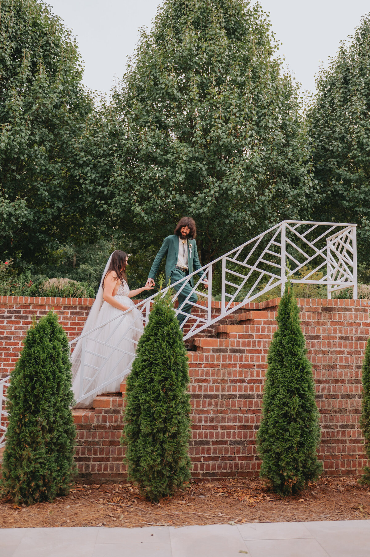 A couple holds hands while walking up steps