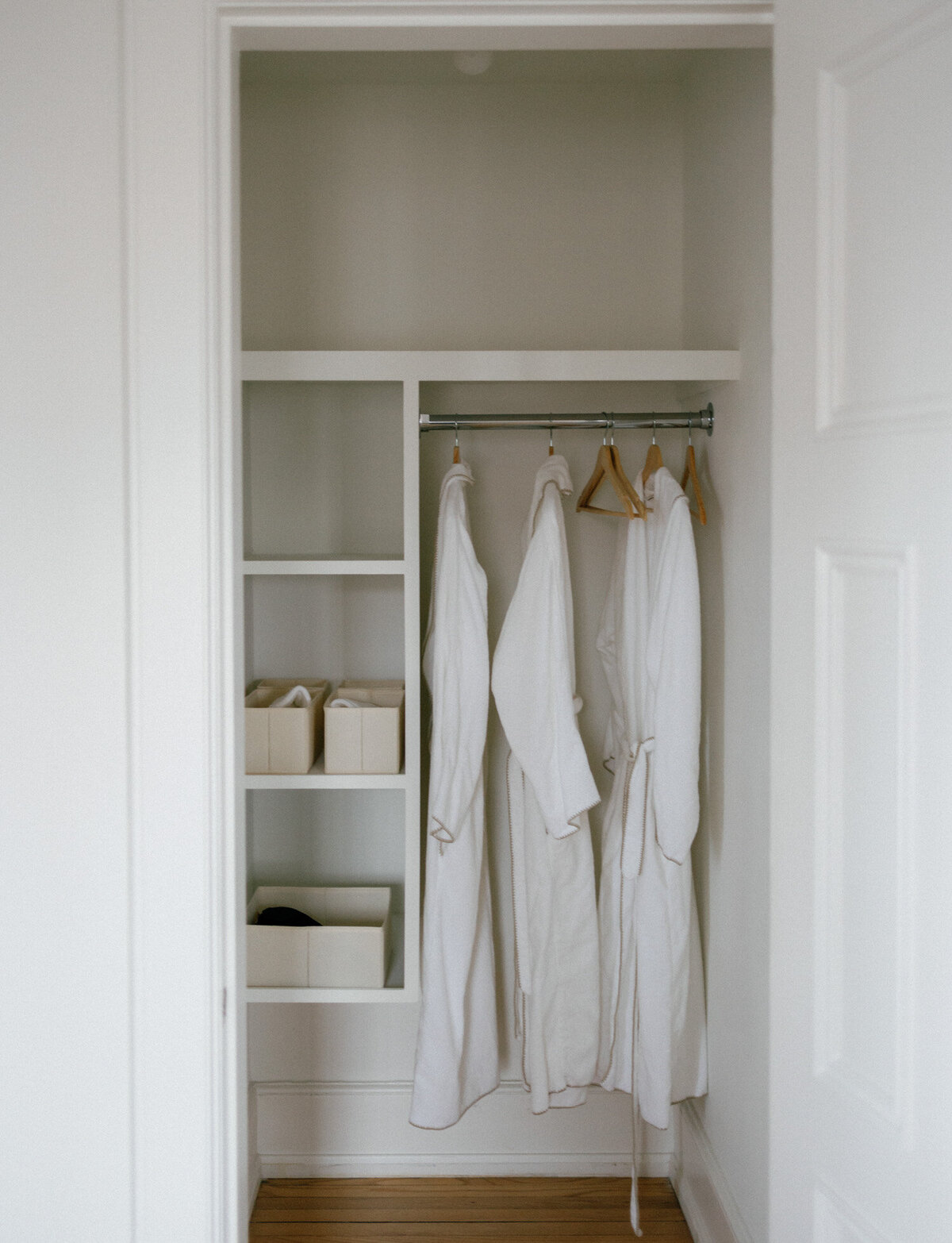 clean white closet with hanging bathrobes, natural light interior photo, bed & breakfast, ALEO Detroit
