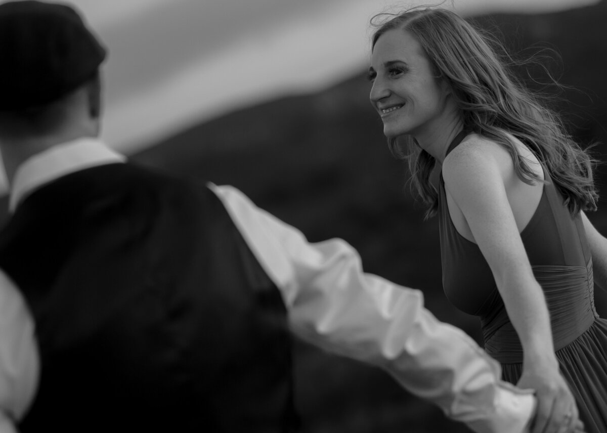 Couple standing against red rock backdrop during Sedona engagement session