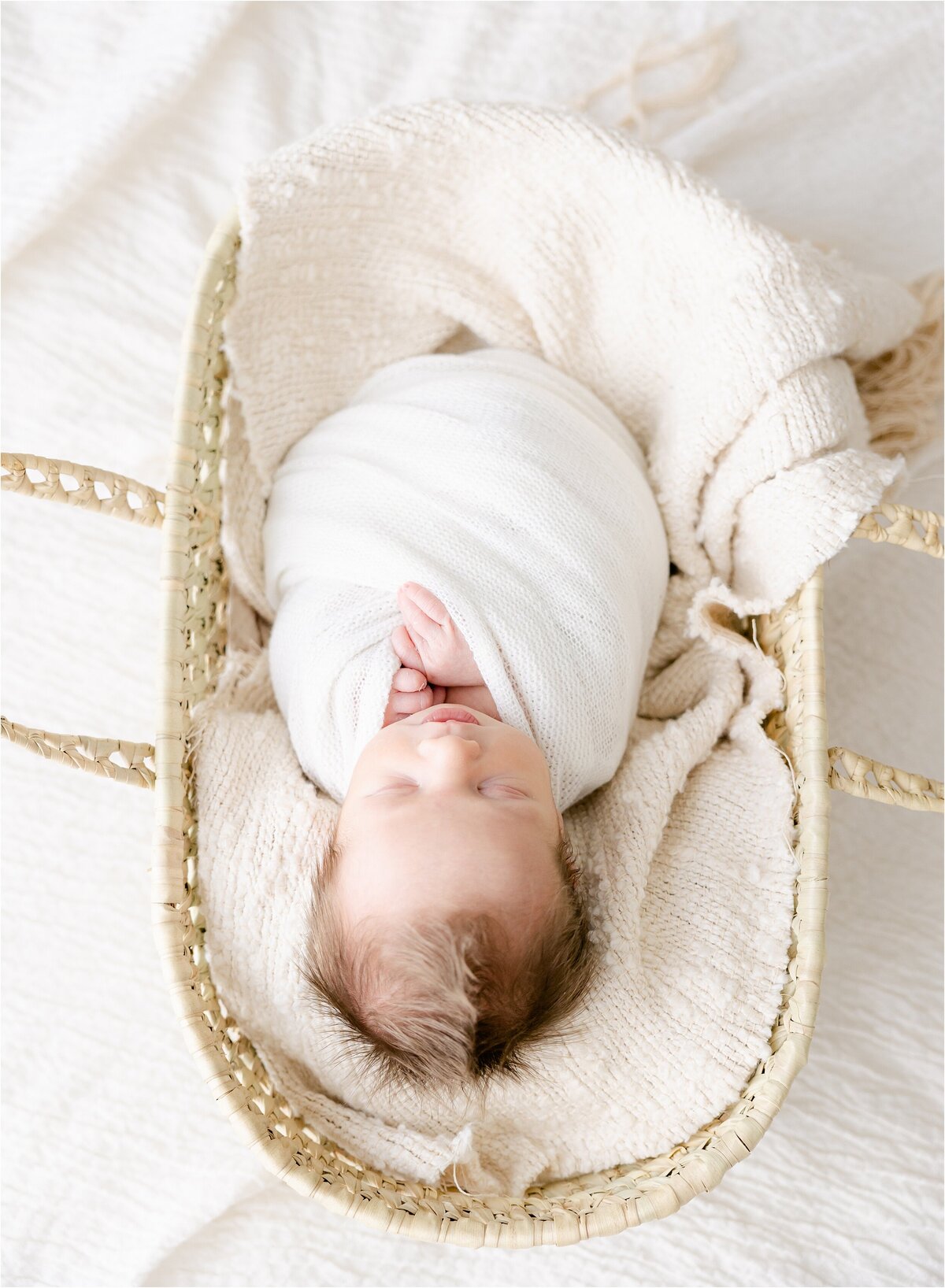 baby boy in moses basket during newborn session
