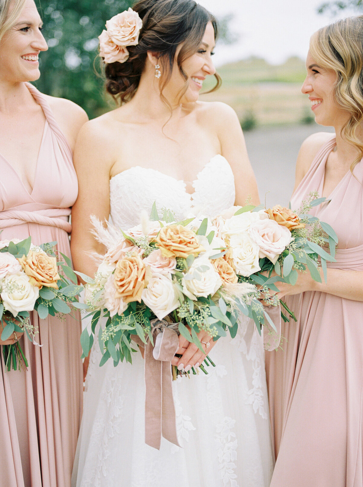 Bright and romantic orange, pink and white bouquet by Lovella Lifestyle, whimsical and romantic Edmonton wedding florist, featured on the Brontë Bride Vendor Guide.