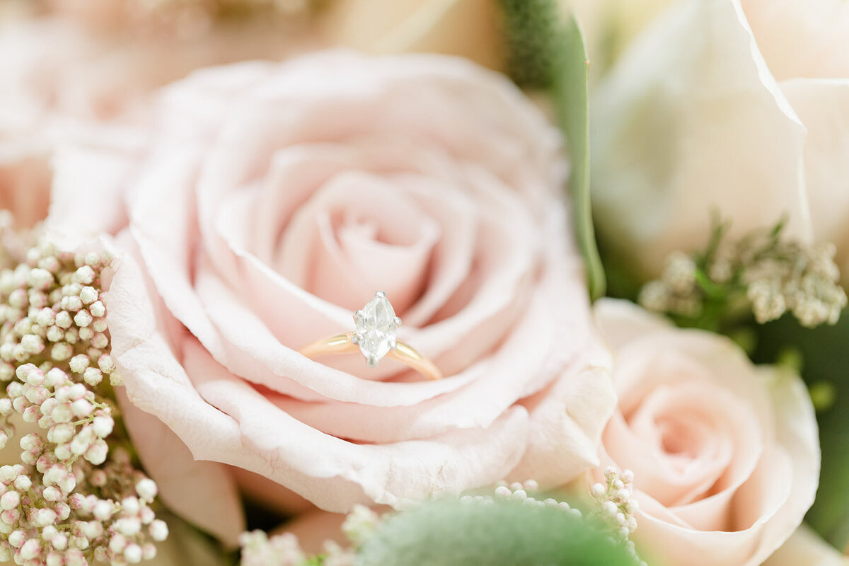 wedding ring on bride's bouquet; pink rose