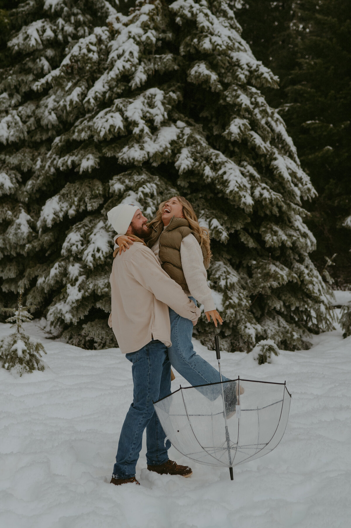 man picks girl up and twirls her to give her a kiss