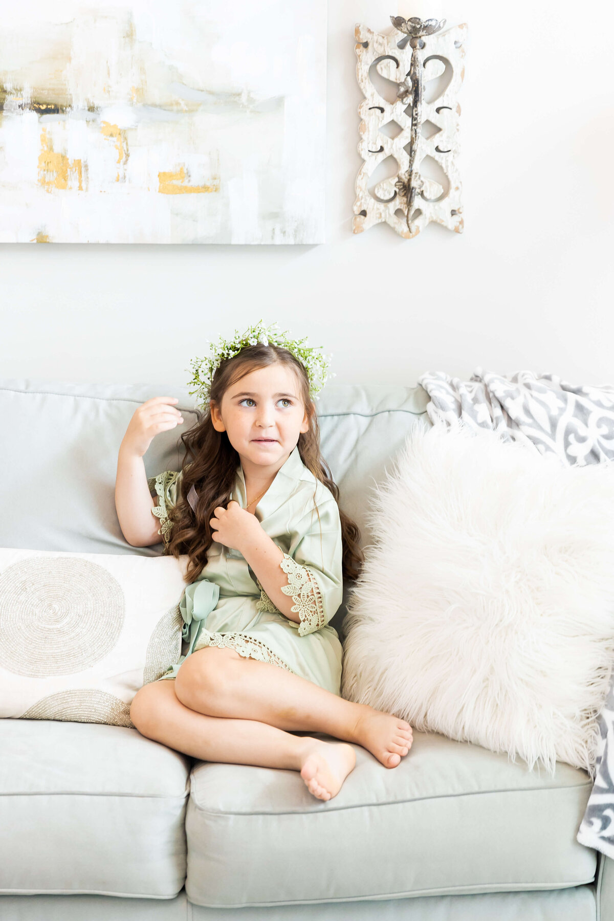 Child sitting on sofa at wedding at  Ruby Cora wedding venue in Clarksville, TB