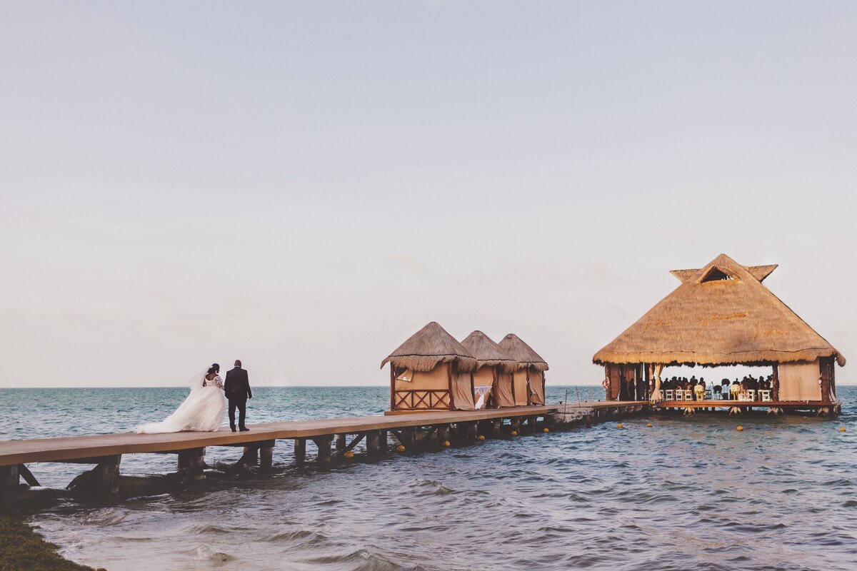 Bride walks with father to wedding ceremony in Cancun