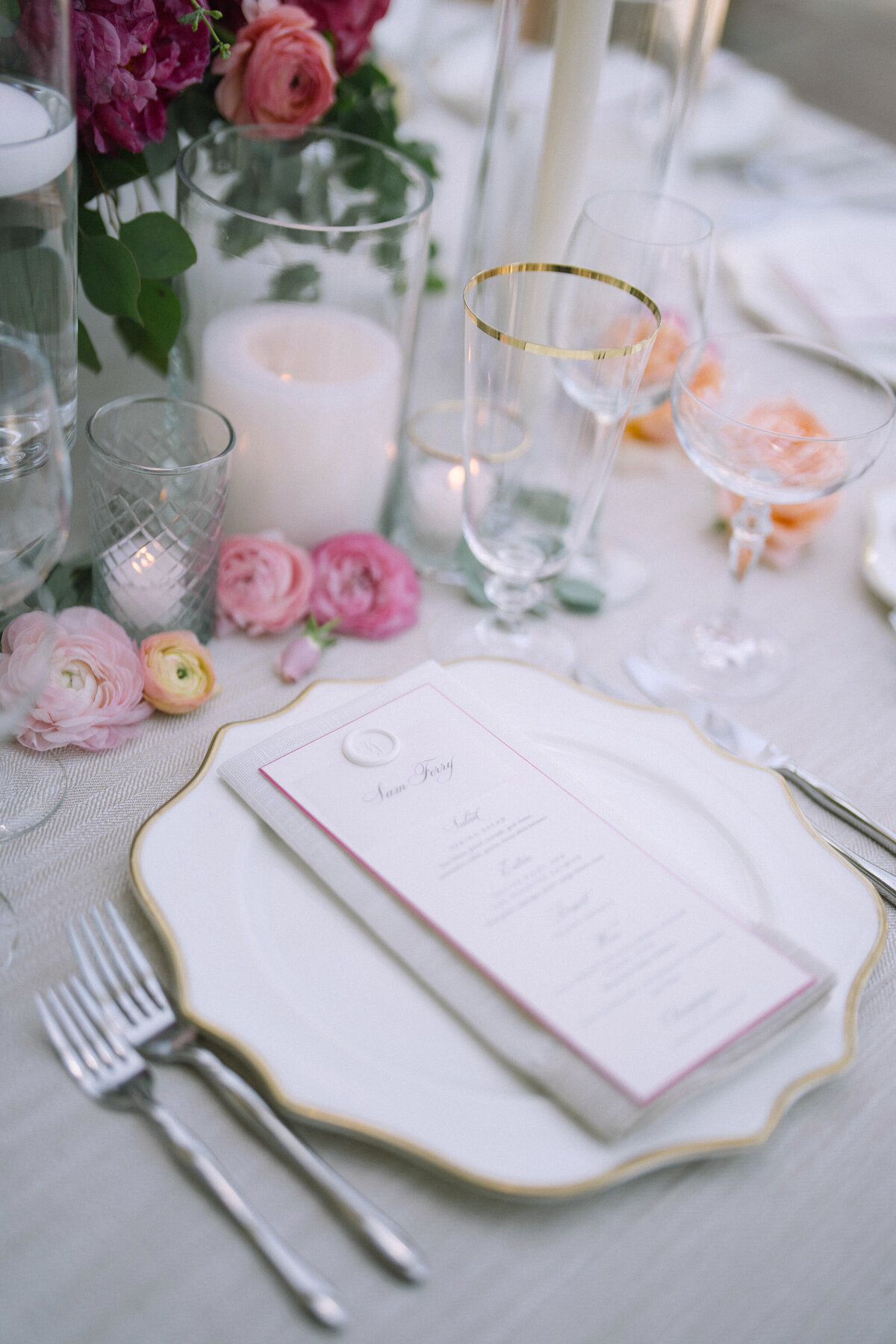 Detailed view of a wedding table setting, featuring candles and floral decorations at Saddle Country Club.