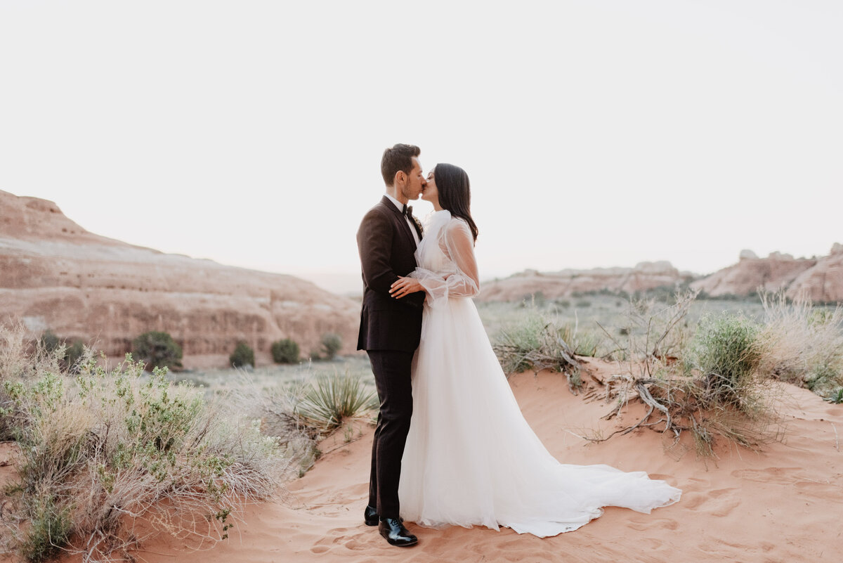 Utah elopement photographer captures bride kissing groom during bridal portraits