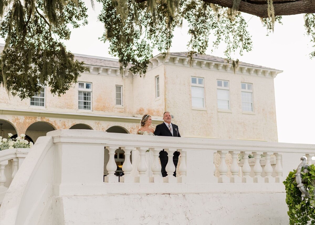 Bride talking with father on terrace at Bella Cosa, Lake Wales, Florida