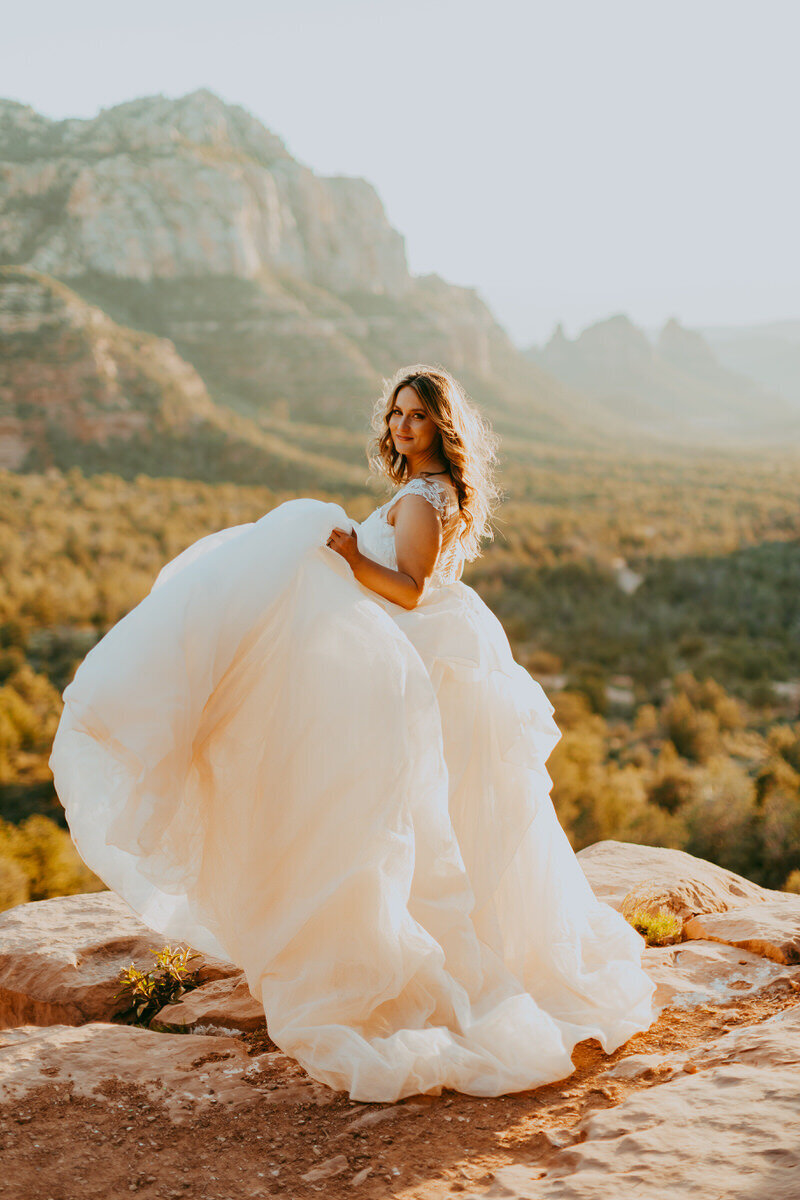 bride dances on the edge of a sedona cliff