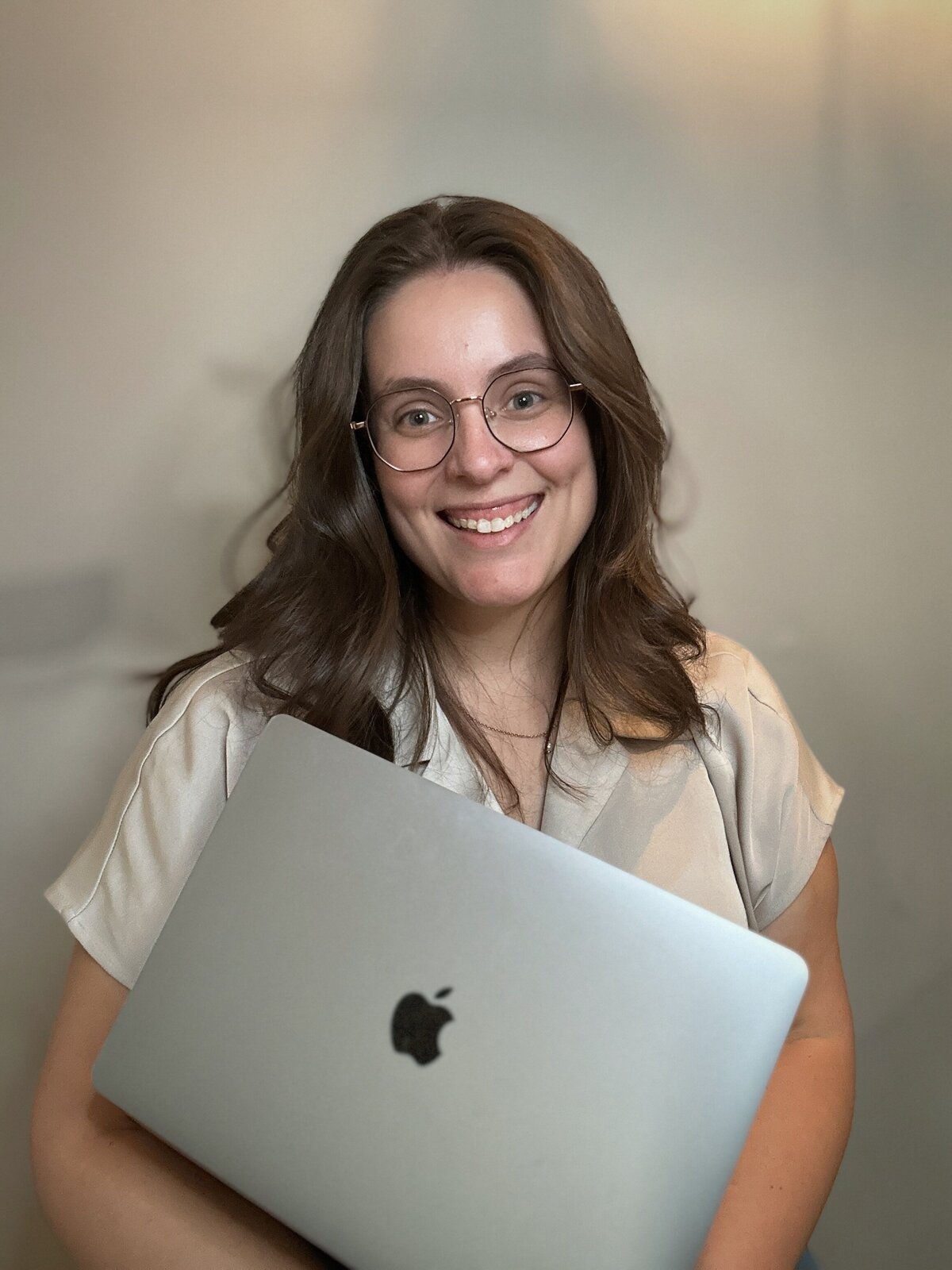 Close-up of Molli Gorrell, a smiling woman with glasses and brown hair, ready to help small business owners with a free discovery call.