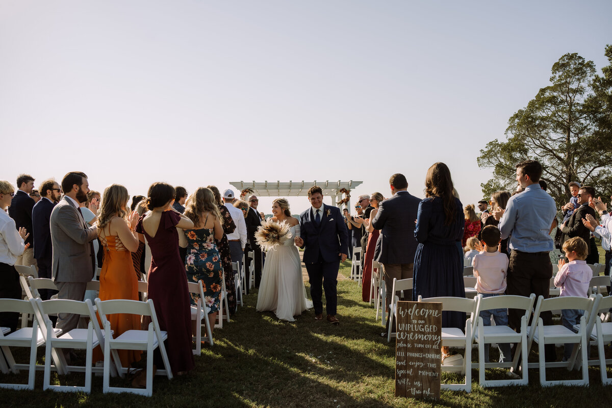 newly weds walking down aisle after ceremony