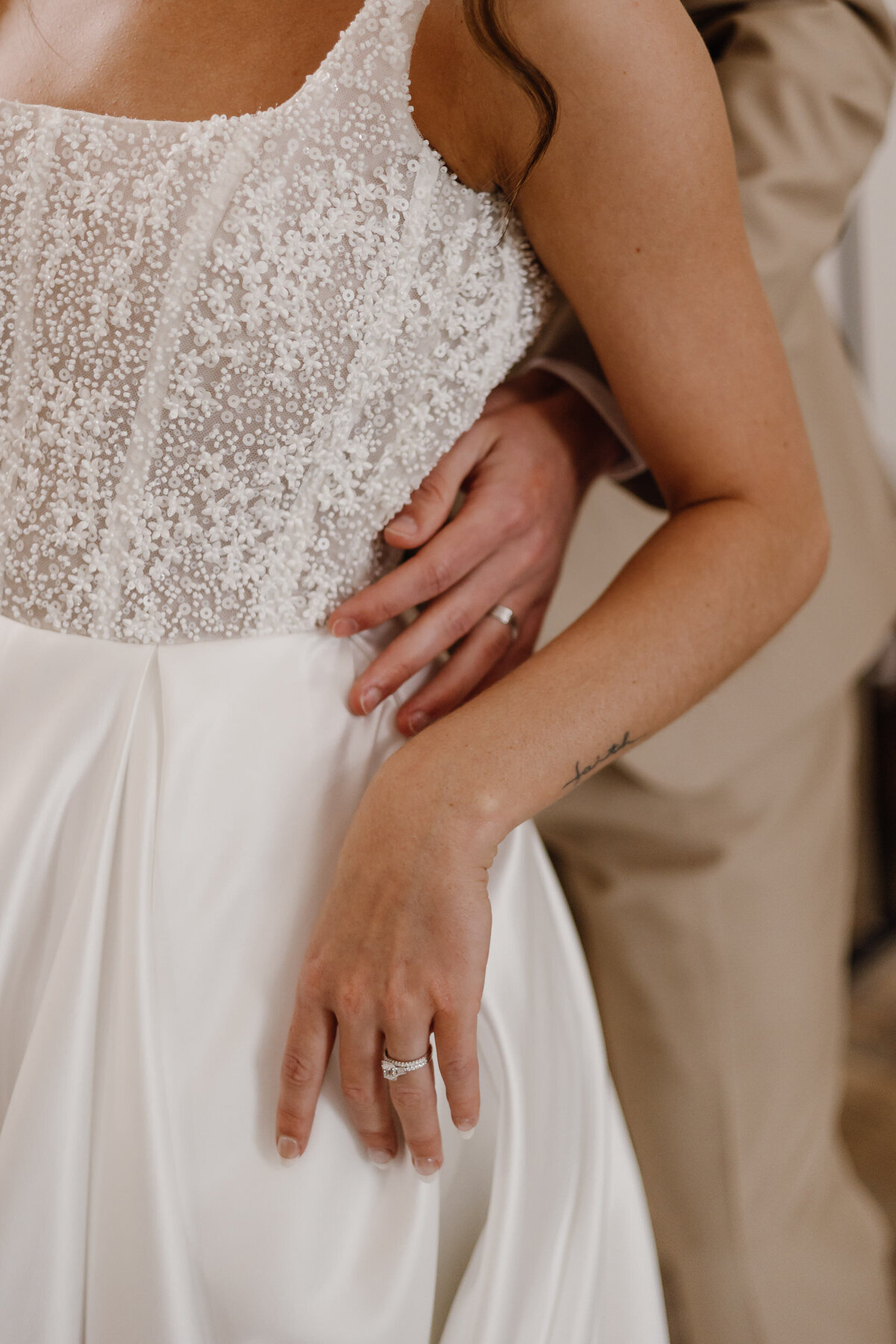 Close up views of two hands wrapped around a person showing off wedding rings