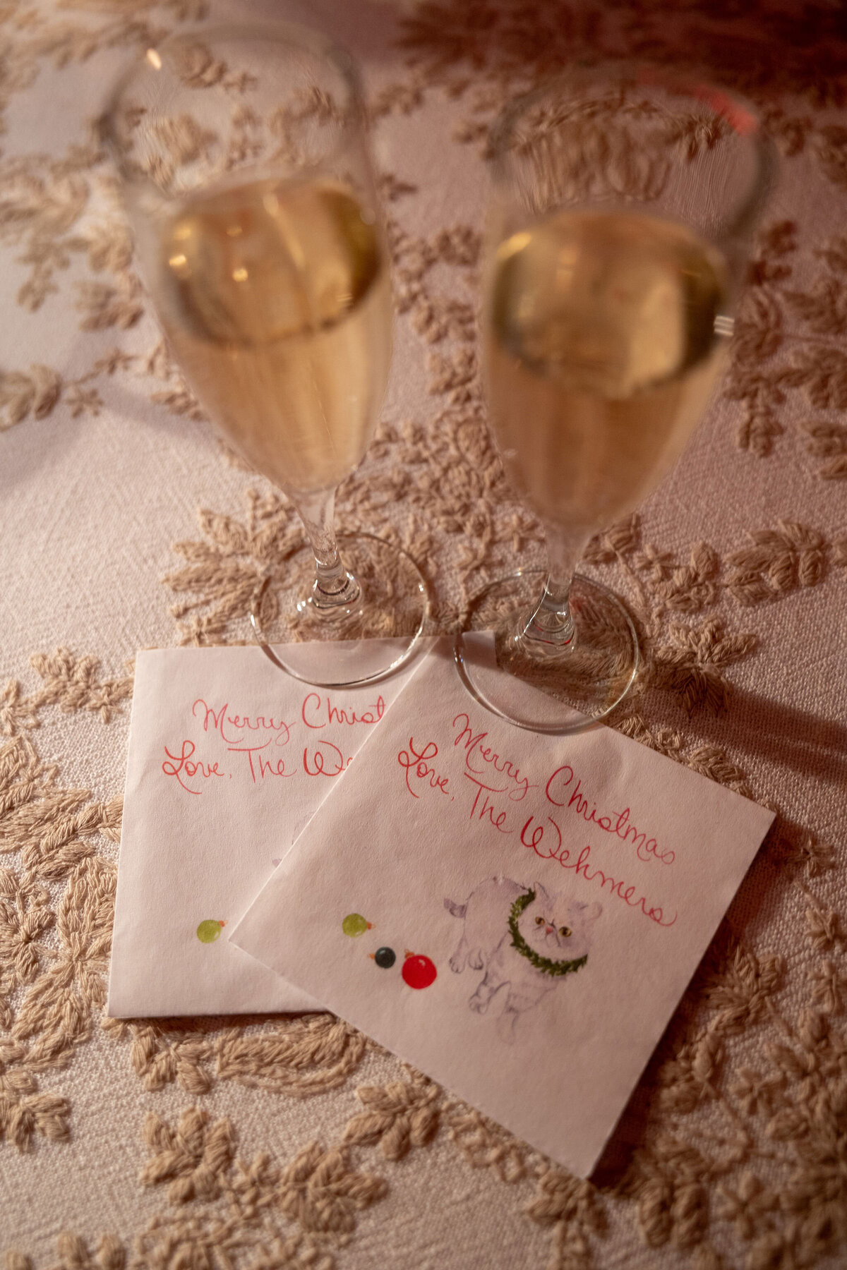 Close up a two Champagne glasses and cocktail napkins.