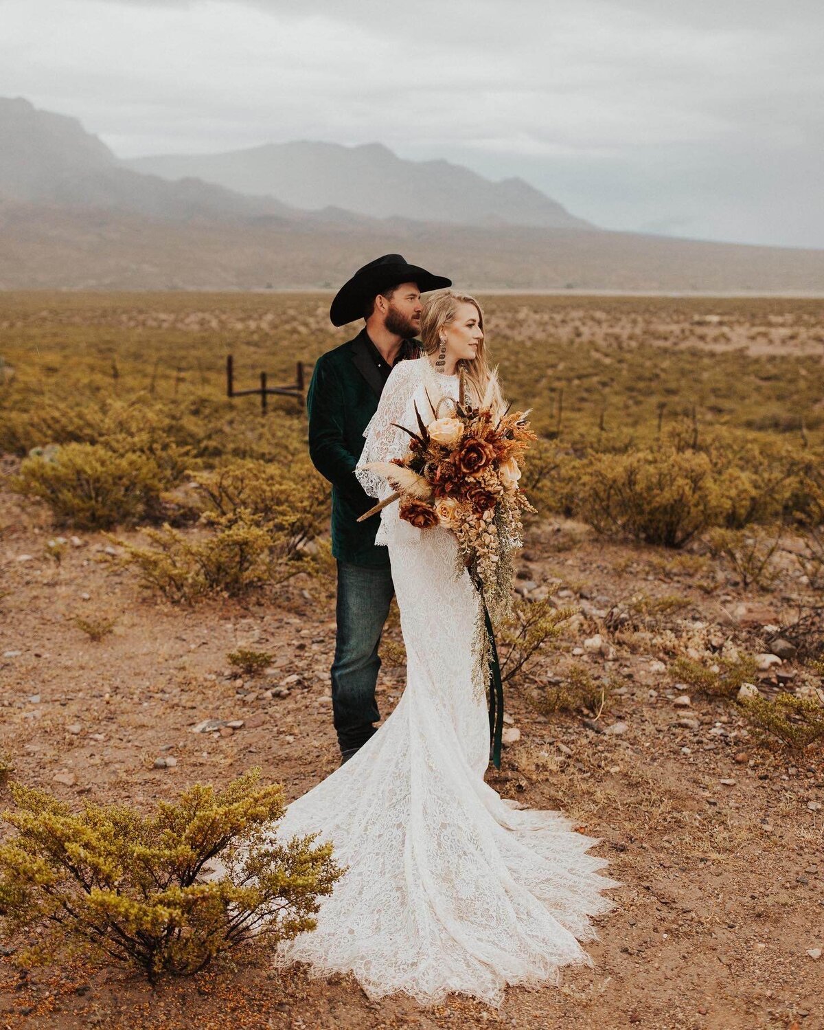 bride and groom posing in desert