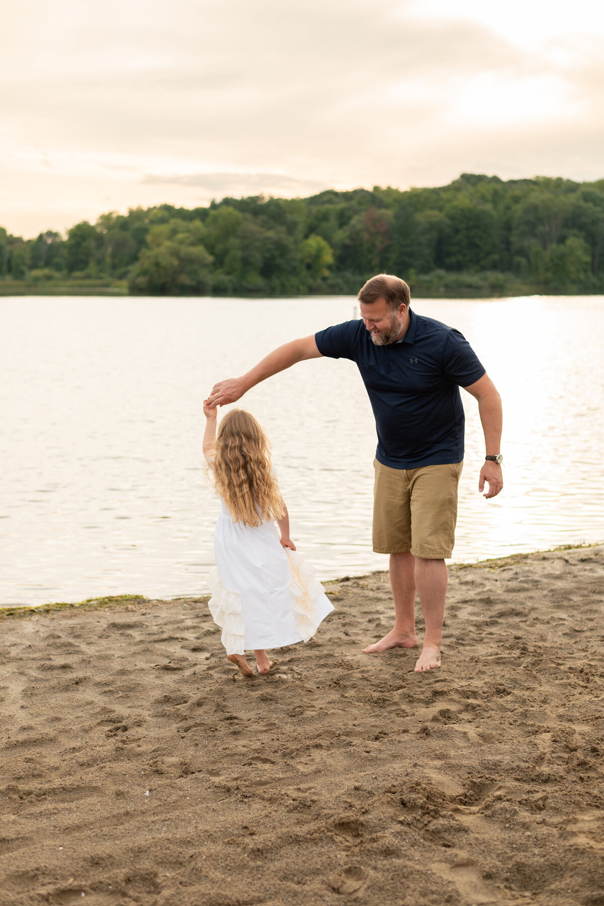 dad-twirling-daughter-beach