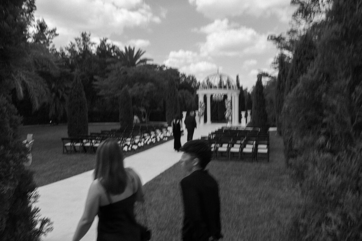Outdoor wedding ceremony under white pergola at La Casa Toscana in Fort Myers